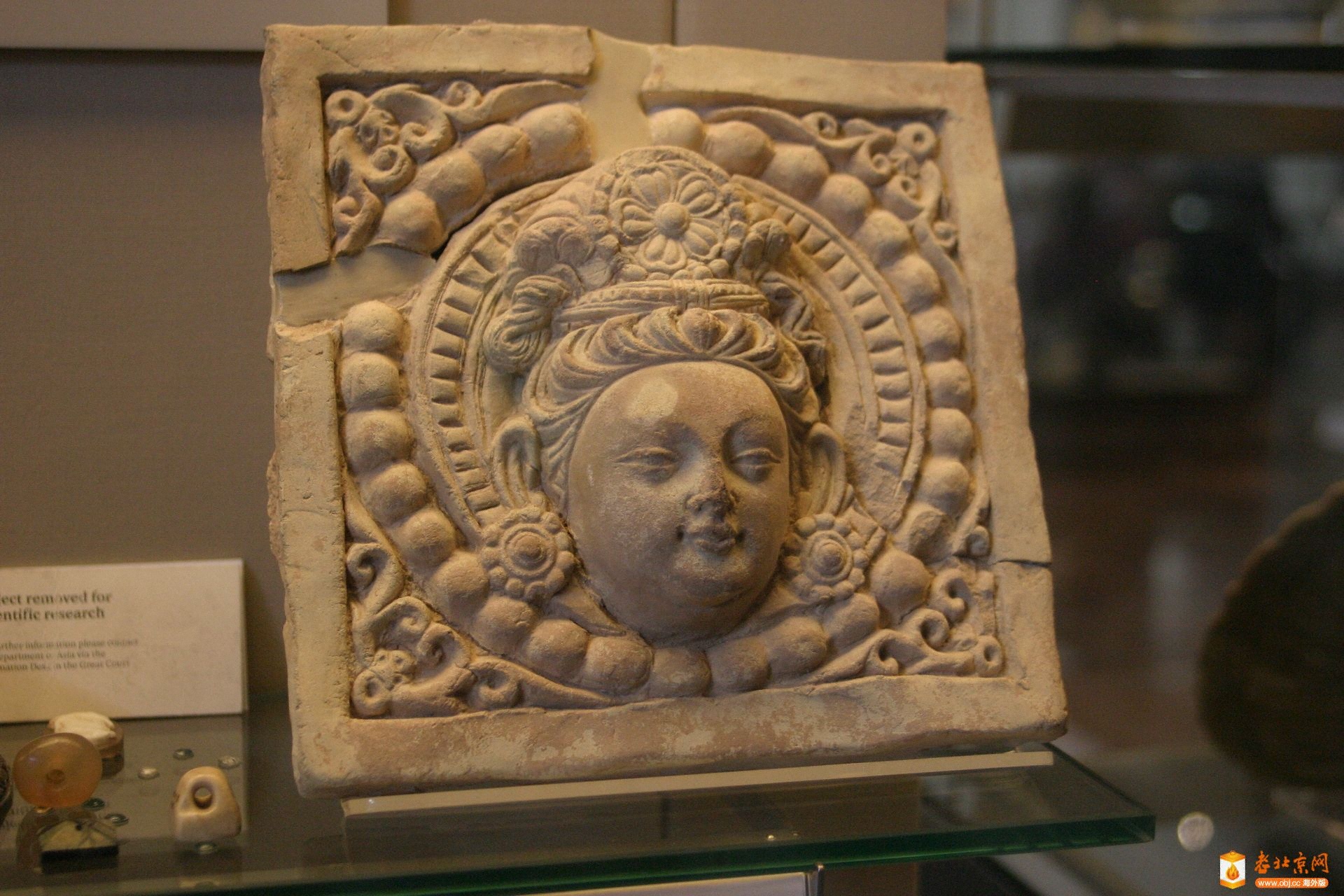 17.ͷStucco plaque with the head of a Bodhisattva surrounded by beaded b.jpg